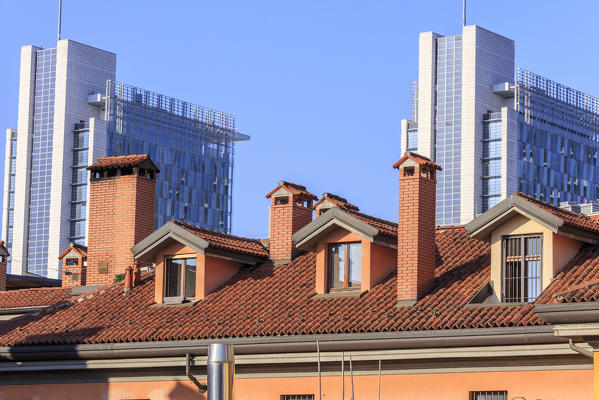 The contrast between old typical houses and new modern buildings and skyscrapers Milan Lombardy Italy Europe