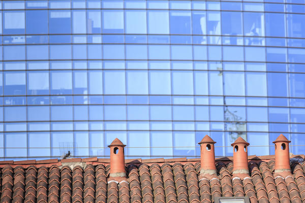 The contrast between old typical houses and new modern buildings and skyscrapers Milan Lombardy Italy Europe