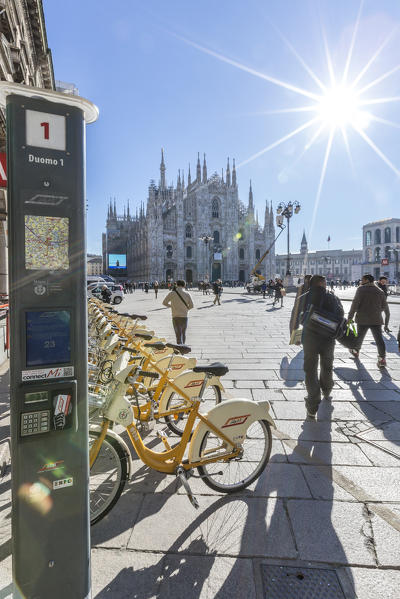 Yellow bicycles and tourists in the main square of town facing the Duomo Milan Lombardy Italy Europe
