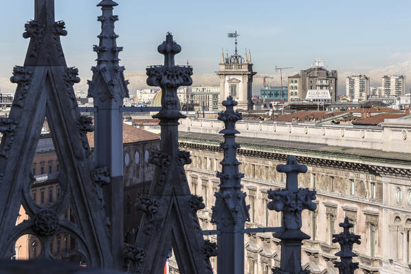 The white marble spiers of the Duomo frame the skyscrapers of Milan Lombardy Italy Europe