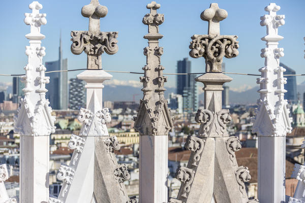 The white marble spiers of the Duomo frame the skyscrapers of Milan Lombardy Italy Europe