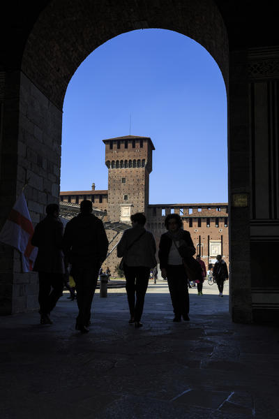 Silhouettes under the arch framing the ancient Sforza Castle Milan Lombardy Italy Europe