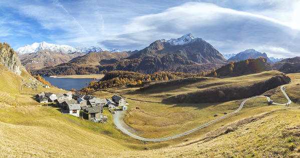 Panorama of huts framed by Lake Sils and colorful woods Grevasalvas Upper Engadine Canton of Graubunden Switzerland Europe