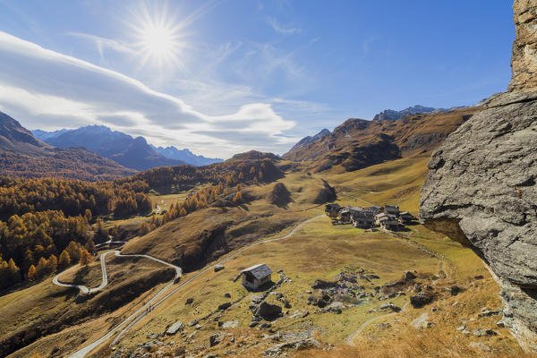 Mountain huts framed by colorful woods in autumn Grevasalvas Plaun da Lej Upper Engadine Canton of Graubunden Switzerland Europe