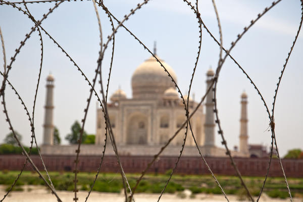 The Taj Mahal is a white marble mausoleum in Agra, India. It is widely considered to be a premier example of Mughal architecture, which combines elements of Indian, Persian, and Islamic styles, and is one of India's top tourist attractions. It is commonly referred to as the Jewel of India. It is also arguably the world's greatest monument of love Agra, India