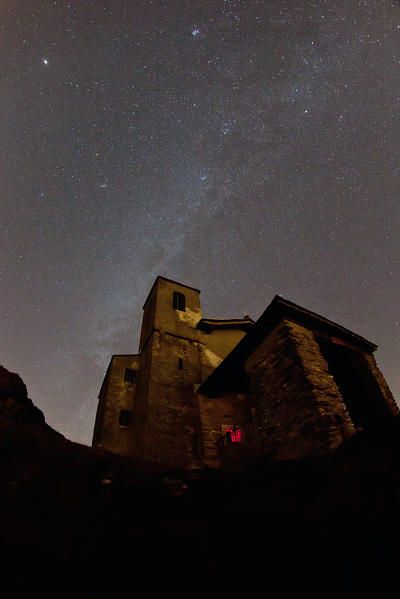 The Milky Way lighting the sky over the Church of Saint Bernard at the Dosso di Musso, along the Monti Lariani trail Lake Como, Lombardy Italy Europe