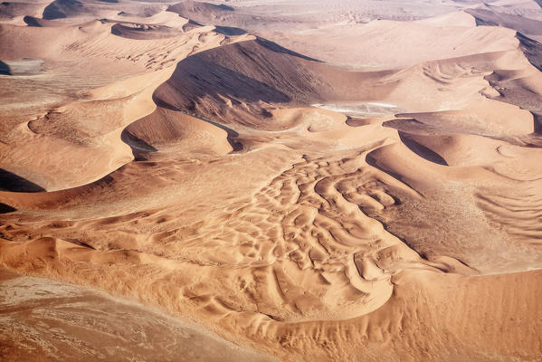 The Namib is an immense expanse of relentlessly moving gravel plains and dunes of all shapes and sizes that stretch along the entire coastline. The most widespread and dominant type of desert sand dune are linear dunes, with crescent shaped dunes common along the coast and clusters of star dunes Namibia Africa