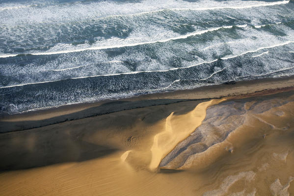 We felt like seabirds as the high-winged Cessna swooped over the dunes and valleys of the sand sea.  The colours shifted constantly, from pale grey to burnt orange and brick red, changing with the light and cloud shadows  Namibia, Africa