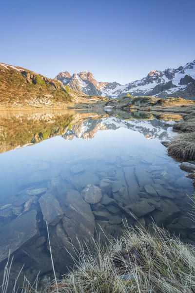 Snowy peaks are reflected in Lake Zana at sunrise Malenco Valley Valtellina Province of Sondrio Lombardy Italy Europe
