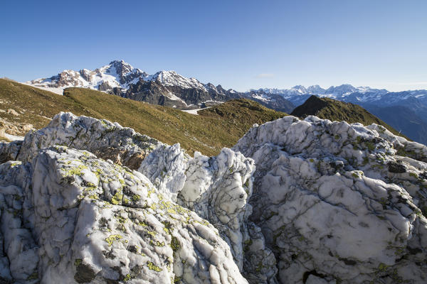 Sasso Bianco frames the snowy peak of Mount Disgrazia Malenco Valley Valtellina Province of Sondrio Lombardy Italy Europe