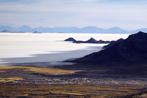 The last lights of the day over the village of Tahua, where you can overnight at the famous Hotel de Sal, almost entirely made of pure salt from the Uyuni Salt Flats, located on the foothills of Thunupa volcano, Bolivia, South America