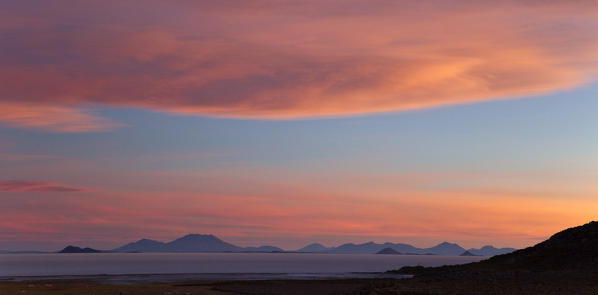 A colourful sunset painting the Andean sky in the Bolivian Salar de Uyuni, Bolivia, South America