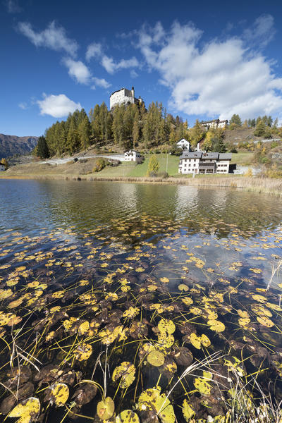 Autumnal leaves fallen in Lake Tarasp frame the old castle Inn district Canton of Graubünden Engadine Switzerland Europe