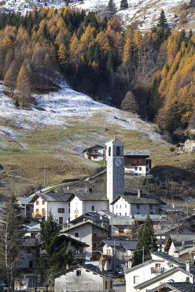 Alpine village surrounded by colorful woods in autumn Isola Spluga Valley Province of Sondrio Valtellina Lombardy Italy Europe