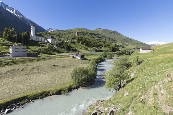 The typical alpine village of Hospental surrounded by creek and green meadows Andermatt Canton of Uri Switzerland Europe