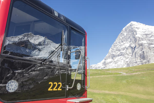 Snowy peak reflected in the window of a wagon of Wengernalpbahn train Wengen Bernese Oberland canton of Bern Switzerland Europe