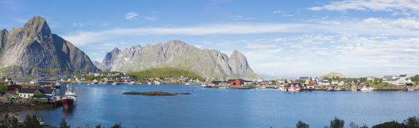 Panorama of the blue sea surrounding the fishing village and rocky peaks Reine Moskenes Lofoten Islands Norway Europe