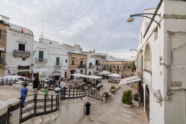 Tourists in the main sqaure of the old medieval town Ostuni province of Brindisi Apulia Italy Europe