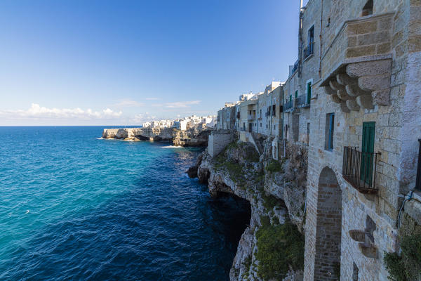 Blue sea framed by the old town perched on the rocks Polignano a Mare province of Bari Apulia Italy Europe