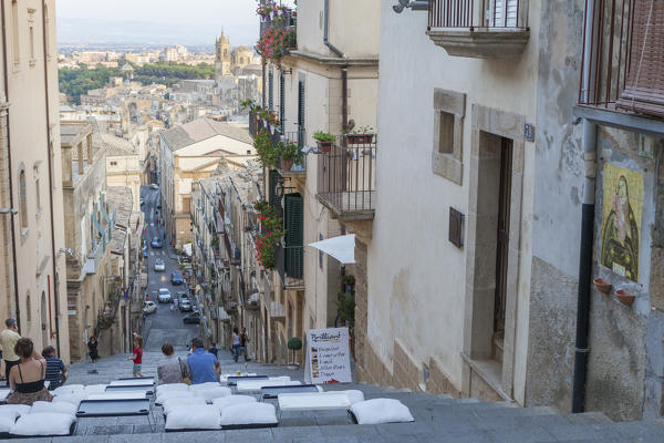 Tourists on flight of steps admire the old town and of Caltagirone province of Catania Sicily Italy Europe