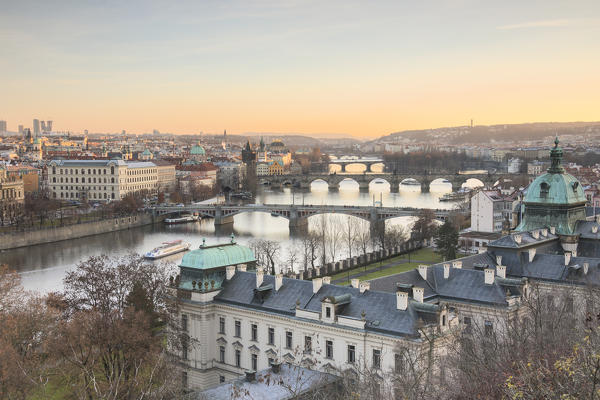 Sunset on the historical bridges and buildings reflected on Vltava (Moldava) river Prague Czech Republic Europe