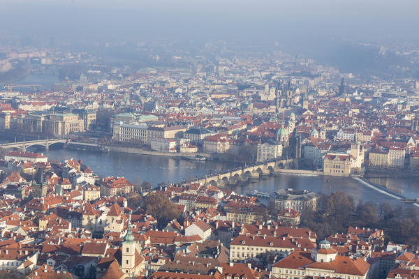 View of typical buildings and ancient churches framed by the river Prague Czech Republic Europe