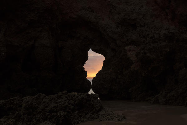View of the sunset sky from a sea cave Praia Dos Tres Irmaos Portimao Algarve Portugal Europe