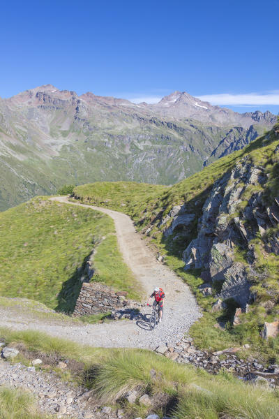 Mountain bike in the green valley framed by rocky peaks Val Di Viso Camonica Valley province of Brescia Lombardy Italy Europe