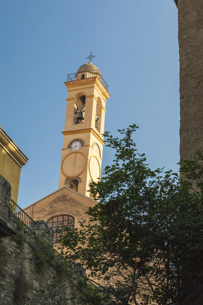 Blue sky and sun on the ancient bell tower of the old town Corte Haute-Corse Corsica France Europe