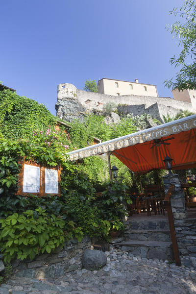 Typical restaurant in the alleys of old town with the citadel in the background Corte Haute-Corse Corsica France Europe