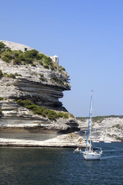 Sail boat in the crystal blue sea surrounded by granite white cliffs Lavezzi Islands Bonifacio Corsica France Europe