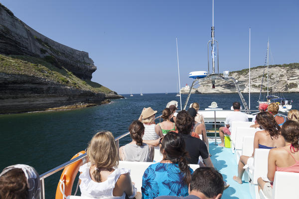 Tourist boat in the blue sea surrounded by granite white cliffs Lavezzi Islands Bonifacio Corsica France Europe