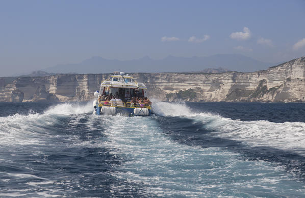 Tourist boat in the blue sea surrounded by granite white cliffs Lavezzi Islands Bonifacio Corsica France Europe