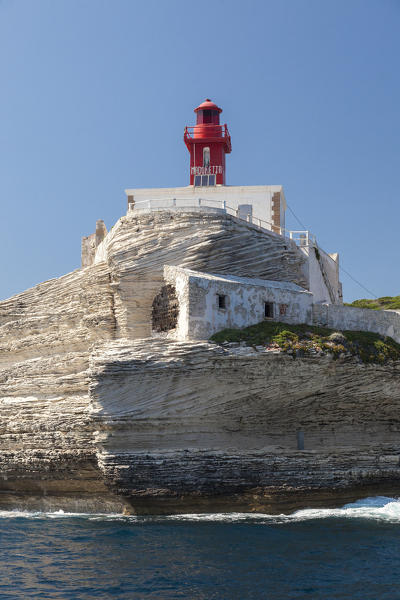The Mediterranean blue sea frames the granite white cliffs and lighthouse Lavezzi Islands Bonifacio Corsica France Europe