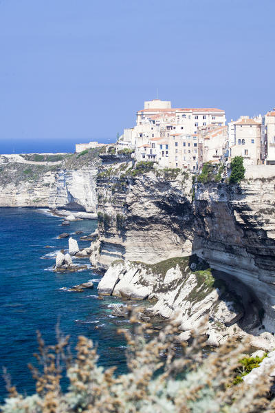 Blue sea frames the medieval old town and fortress perched on top of cliffs Bonifacio Corsica France Europe