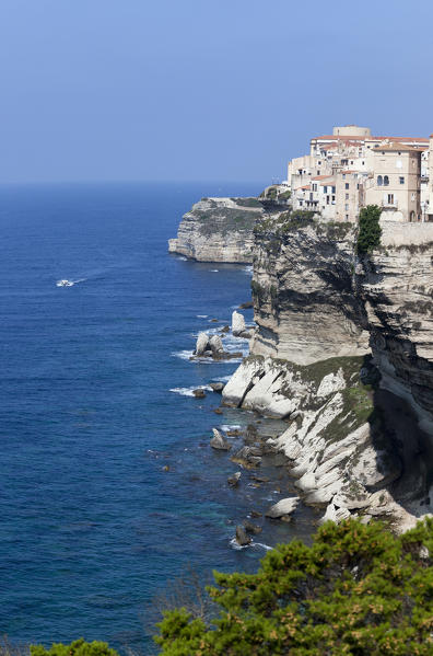 Panorama of the medieval old town and fortress perched on top of cliffs framed by the blue sea Bonifacio Corsica France Europe