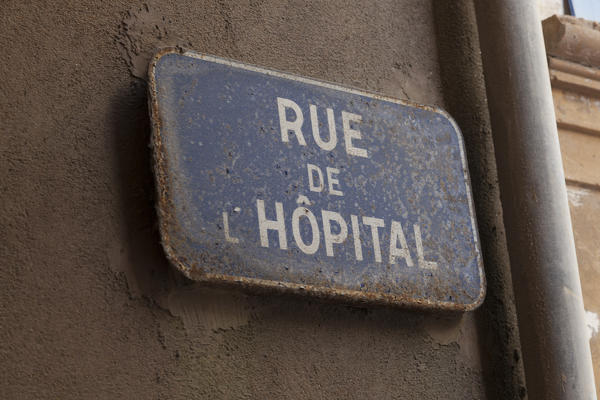 Details of a plaque with street name in the medieval alley of the old town Bonifacio Corsica France Europe