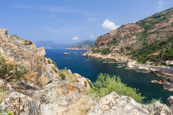 Blue sky and sun on the blue sea surrounded by granite cliffs and plants Porto Southern Corsica France Europe