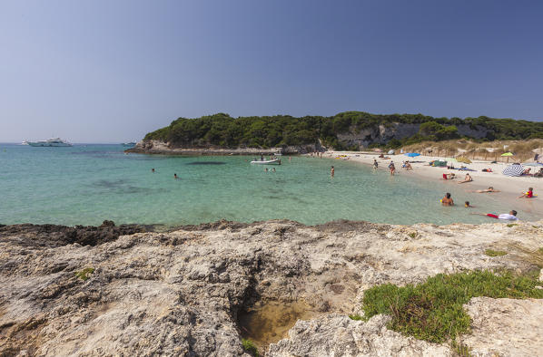 Limestone rocks and turquoise sea frame the sandy beach of Sperone Bonifacio South Corsica France Europe