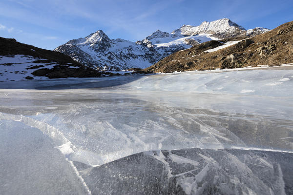 Blue sky on the frozen Lej Nair surrounded by snowy peaks Bernina Pass Canton of Graubünden Engadine Switzerland Europe
