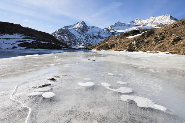 Blue sky on the frozen Lej Nair surrounded by snowy peaks Bernina Pass Canton of Graubünden Engadine Switzerland Europe