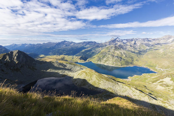Blue sky and clouds frame the Lago Nero and Lake Montespluga in summer Chiavenna Valley Valtellina Lombardy Italy Europe
