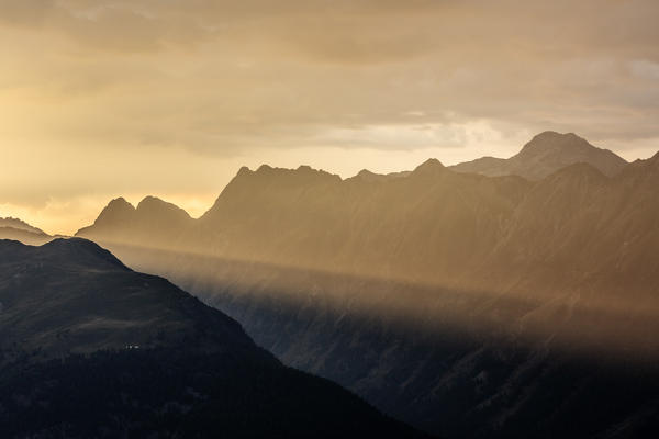 Rays of lights at sunset on the rocky peaks of Muottas Muragl St.Moritz Engadine Canton of Graubünden Switzerland Europe