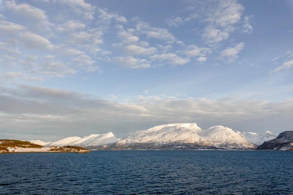 Blue sky on the snowy peaks surrounded by frozen sea Olderdalen Kafjorden Lyngen Alps Tromsø Norway Europe