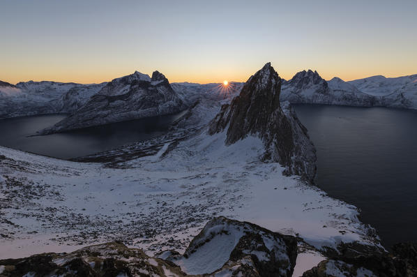 View of Mount Segla from peak Hesten with village of Fjordgard on left in Ornfjorden and Mefjorden on right Senja Norway Europe