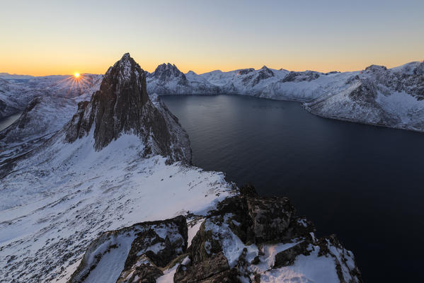 View of Mount Segla and  frozen sea along the Mefjorden from peak Hesten at dawn Senja Norway Europe