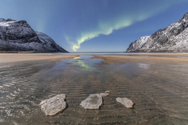 Sandy beach and snowy peaks framed by the Northern Lights in the polar night Ersfjord Senja Tromsø Norway Europe