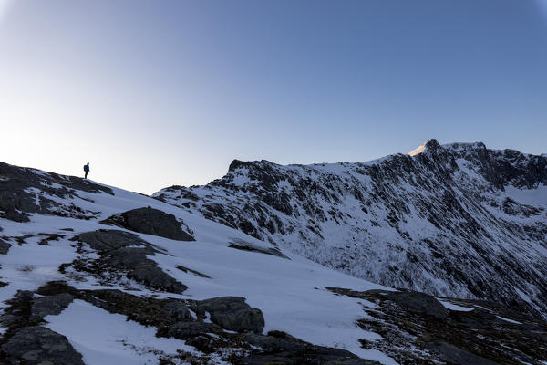 Hiker on the way to climb to the peak of Mount Barden Senja Tromsø Norway Europe
