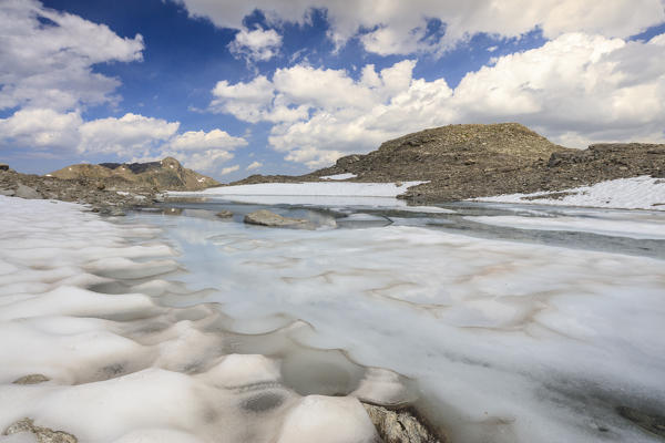 Ice and snow during summer thaw of the alpine lake Joriseen Jörifless Pass canton of Graubünden Engadin Switzerland Europe