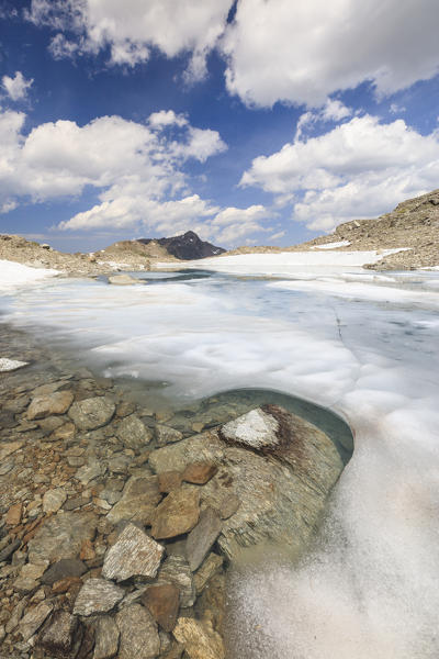 Ice and snow during summer thaw of the alpine lake Joriseen Jörifless Pass canton of Graubünden Engadin Switzerland Europe